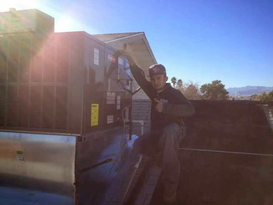 HVAC technician performing Air Duct Repair on a rooftop unit in Mira Monte